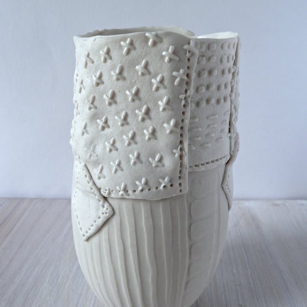 A delicate porcelain vase with impressed and resist decoration.