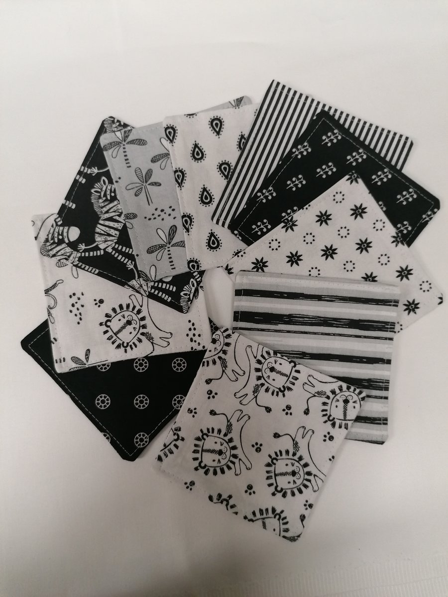 Set of 10 cotton fabric coasters in grey scale. 