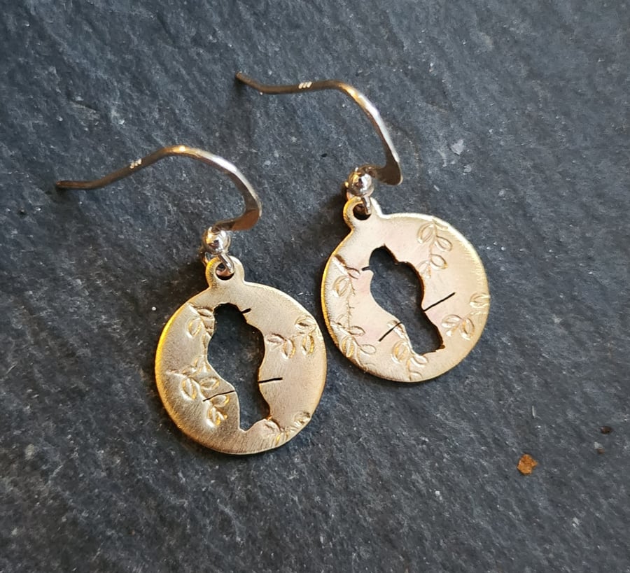 Brass circles with bird on branch cut out