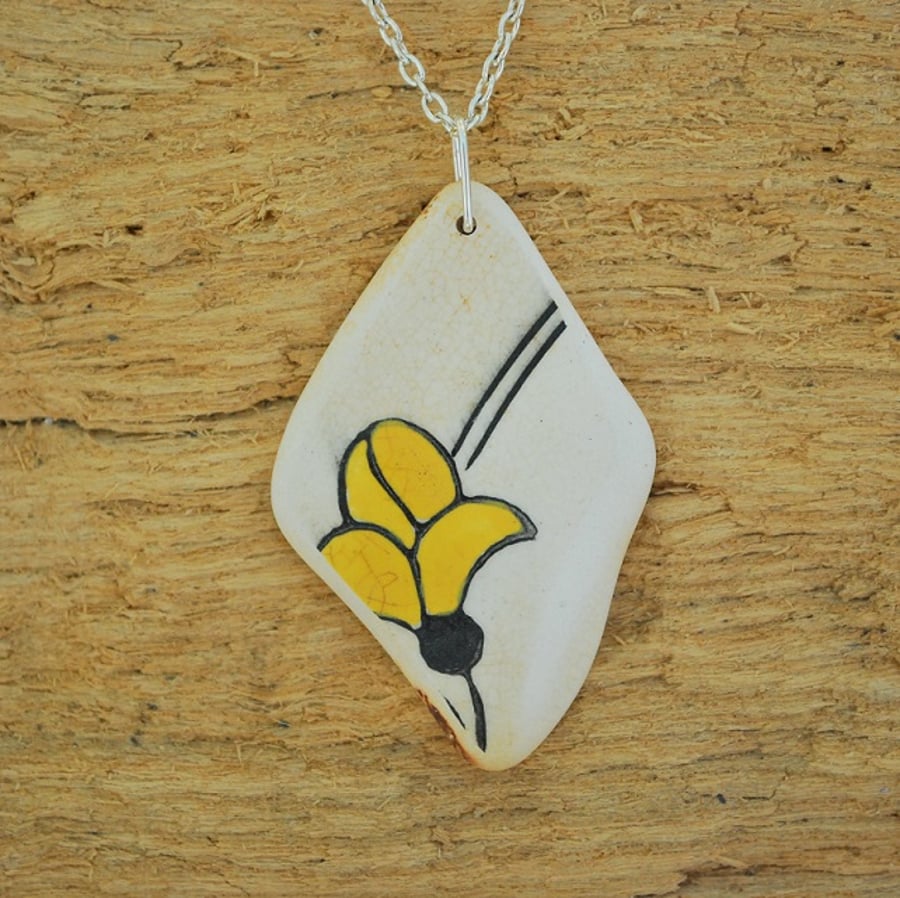 Beach pottery pendant with yellow flower