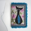 Needle case with appliquéd cat and crochet trim