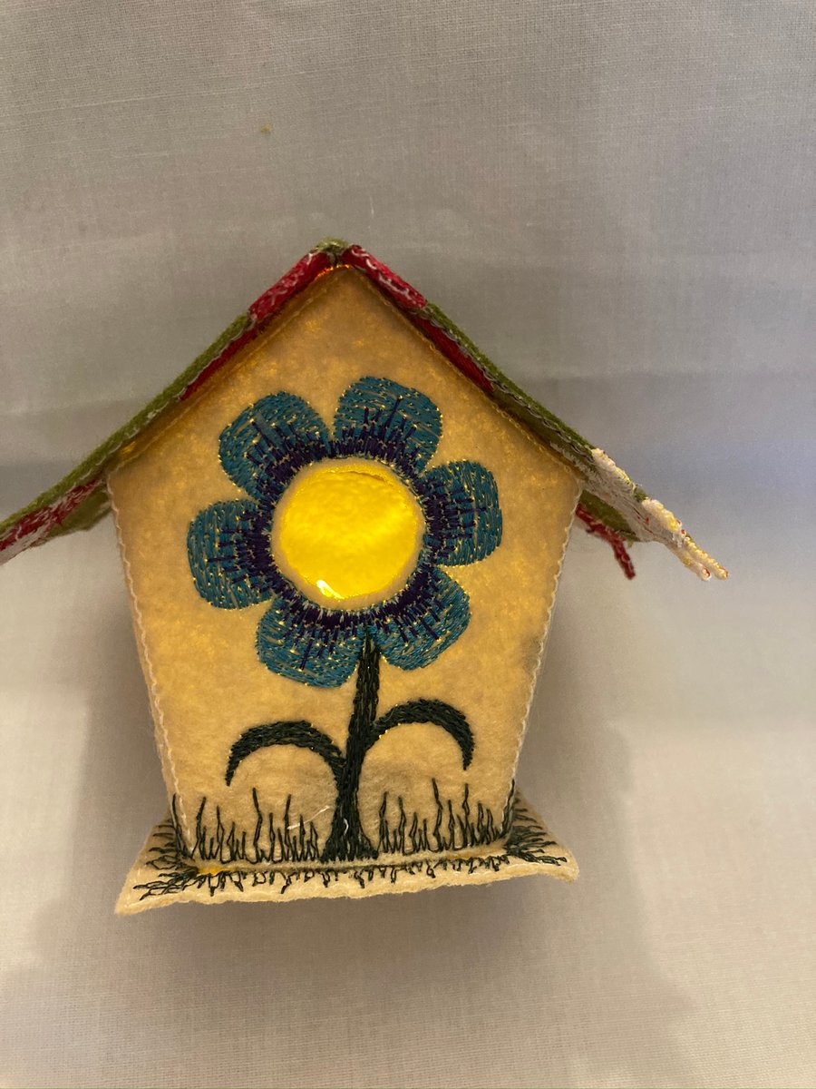 Embroidered fabric tea light bird house. 