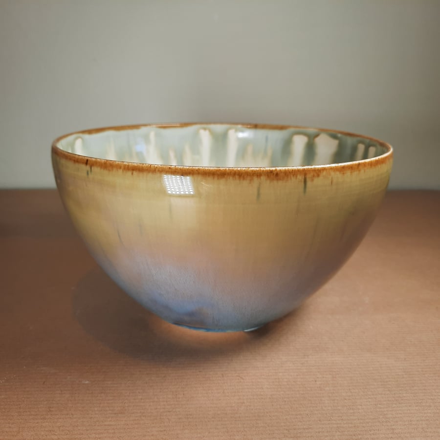 A hand made mustard glazed ceramic bowl