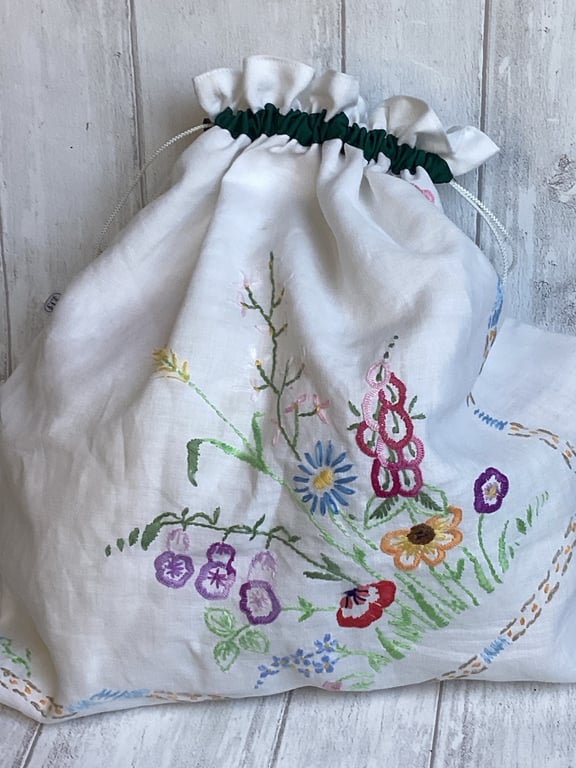 Travel packing laundry bag made from vintage embroidered cloth. Green trim 