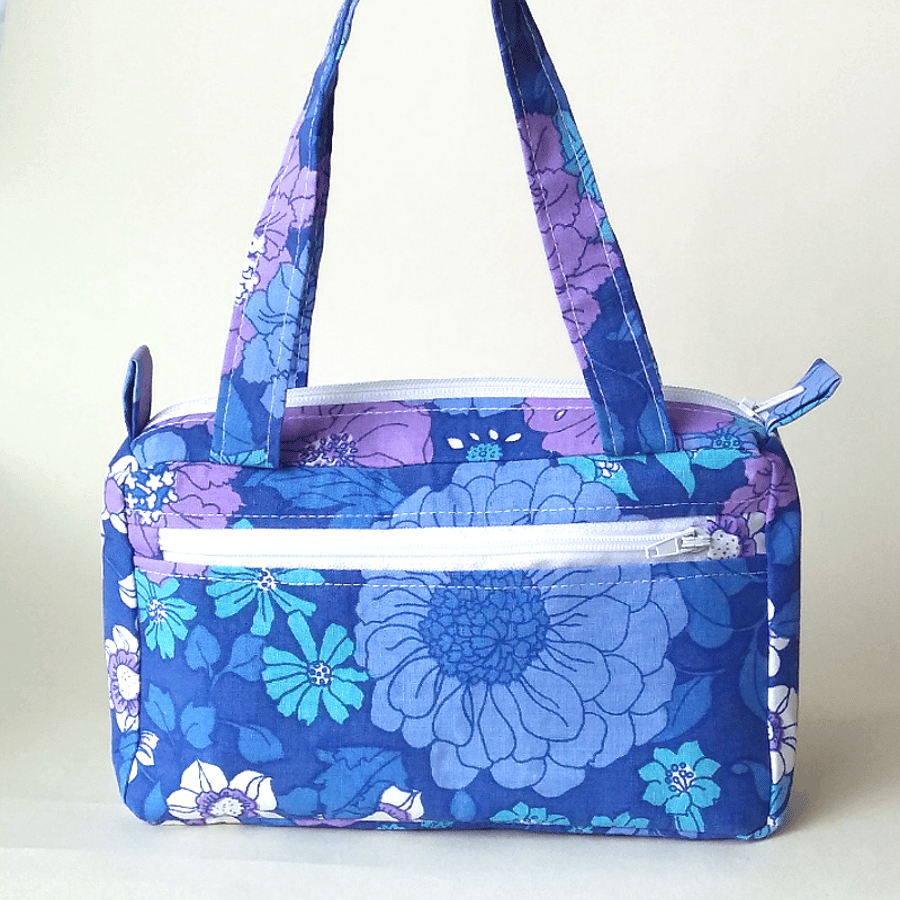 Small, boxy handbag in blue retro, floral print