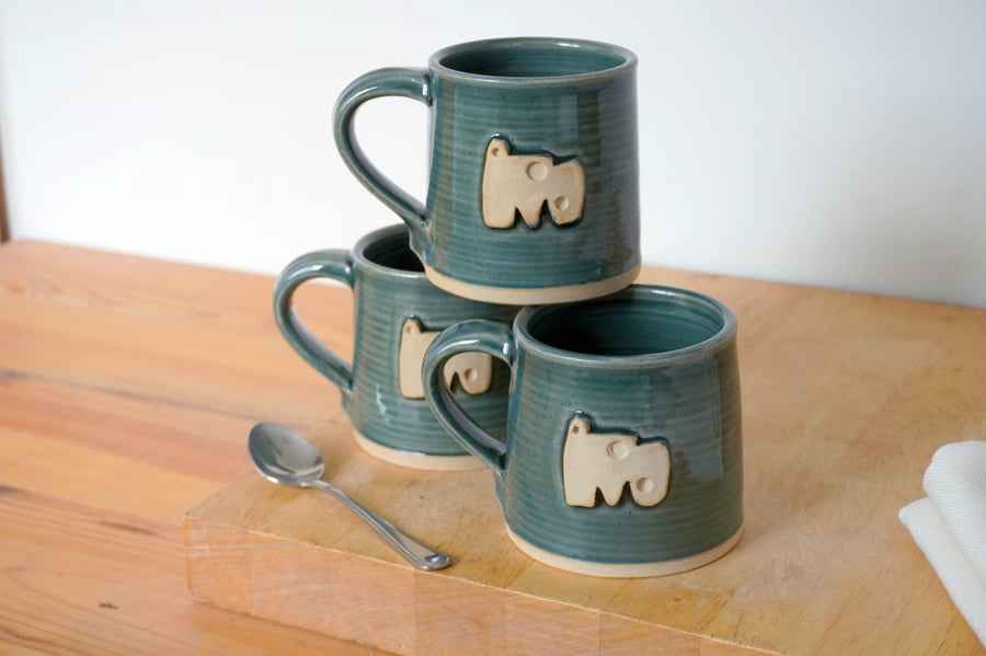 Straight sided hand thrown pottery mug with abstract shape motif glazed in blue