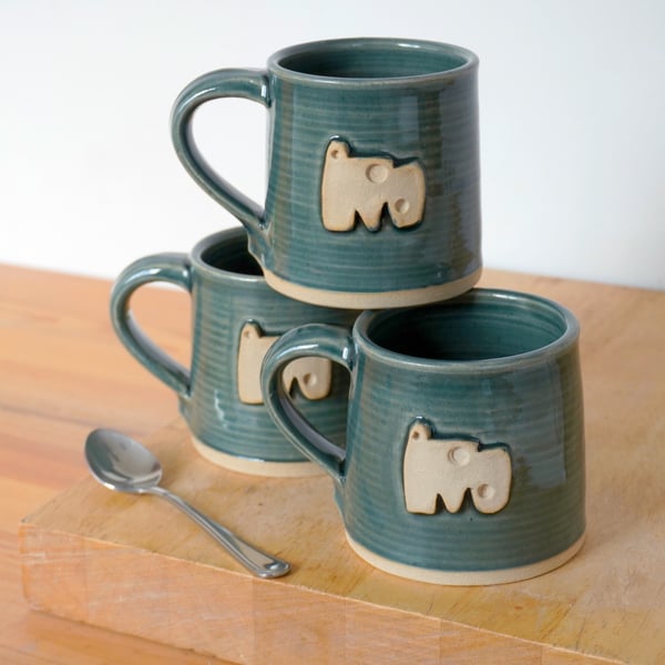 Straight sided hand thrown pottery mug with abstract shape motif glazed in blue