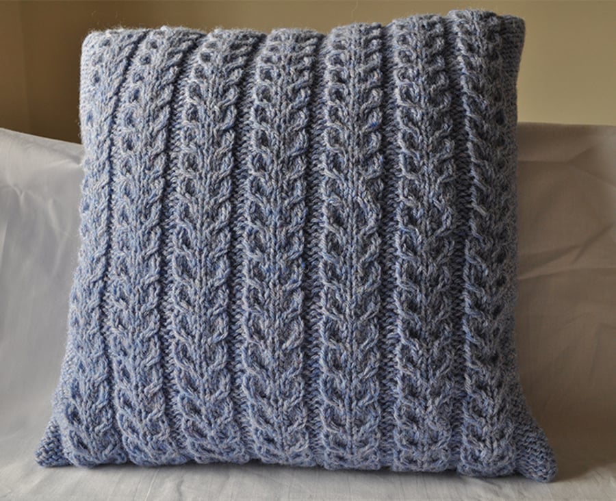 Blue hand knitted cushion made from aran wool