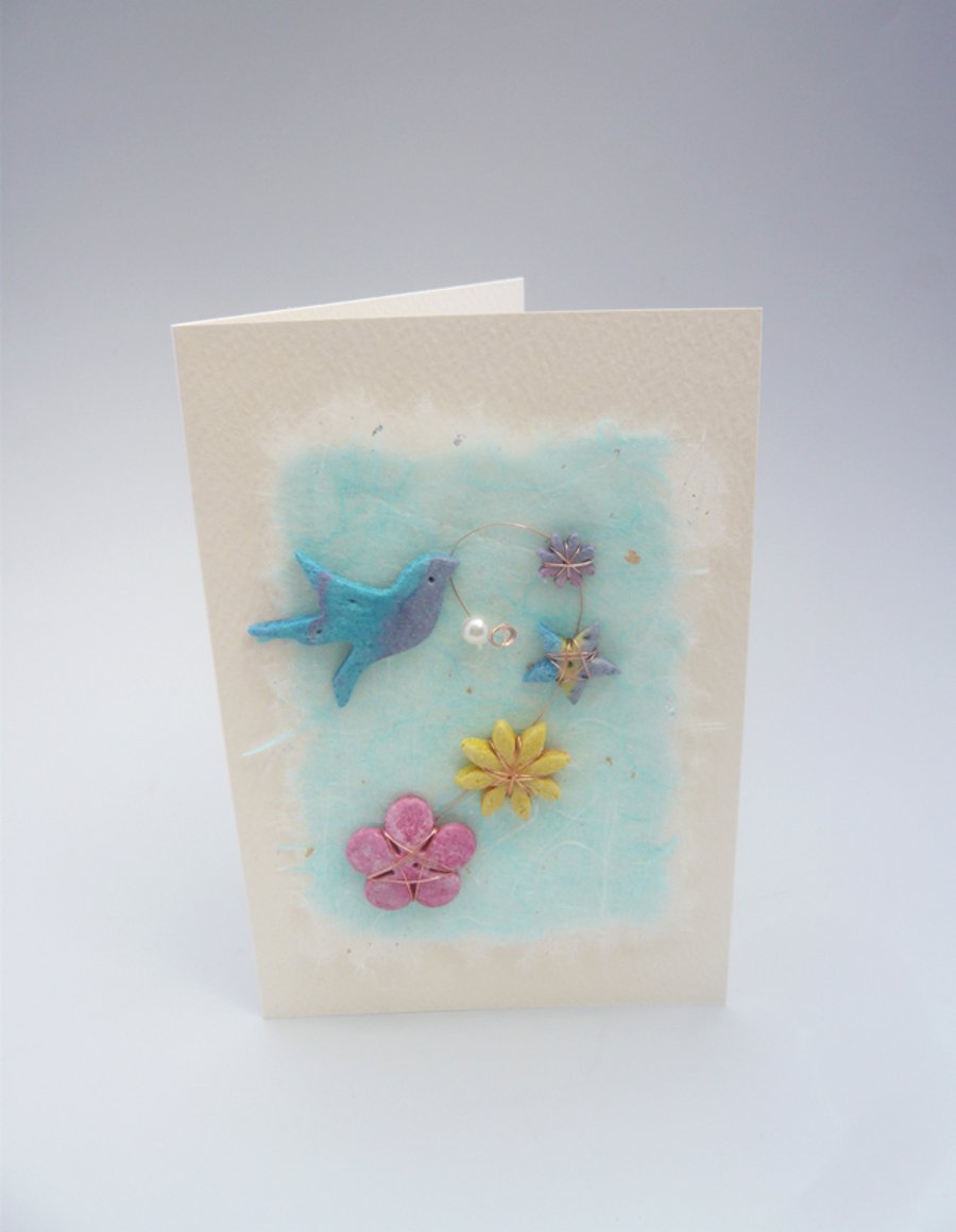 Birthday card. Blue bird with flowers.