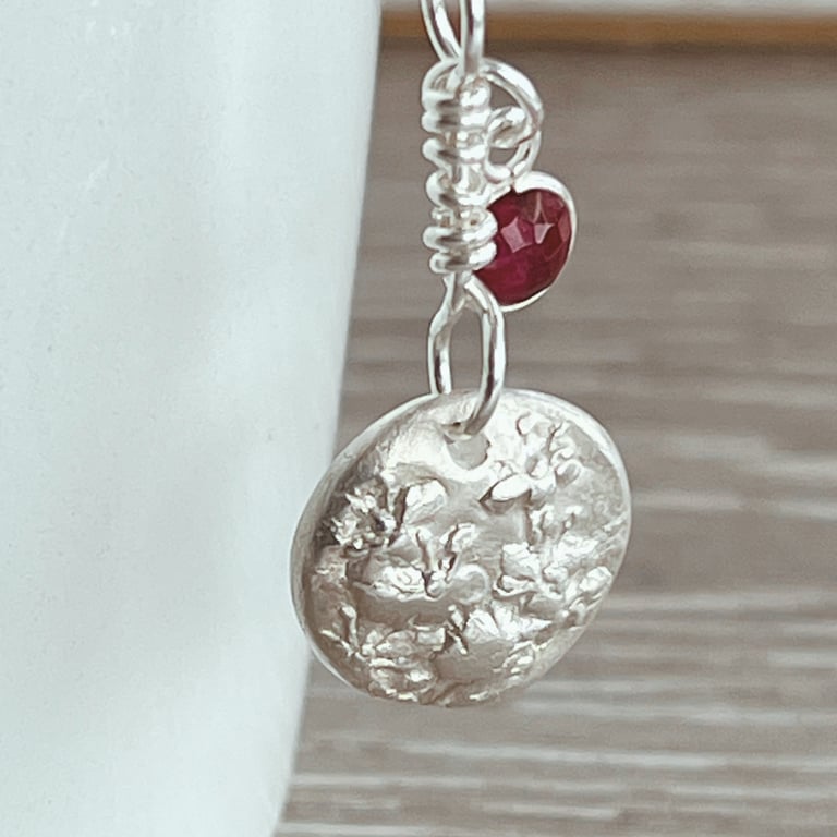 Botanical silver pendant with ruby charm on silver chain