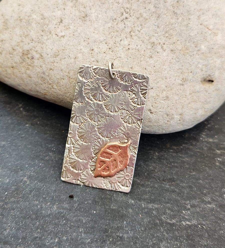 Oblong pendant in sterling silver with etched copper leaf