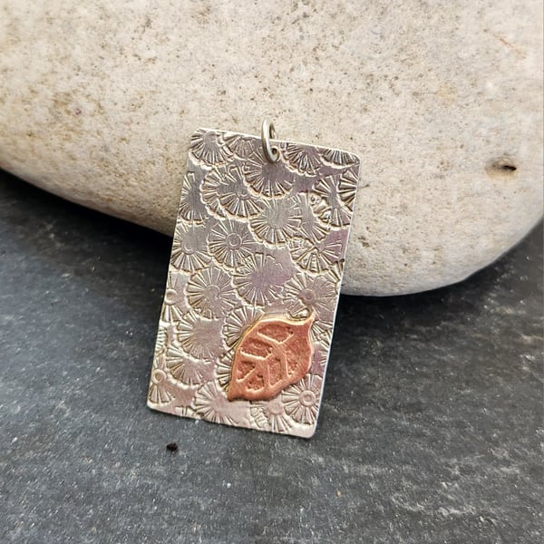 Oblong pendant in sterling silver with etched copper leaf