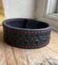 Black, Skull tooled leather bracelet cuff with wine coloured stitching.