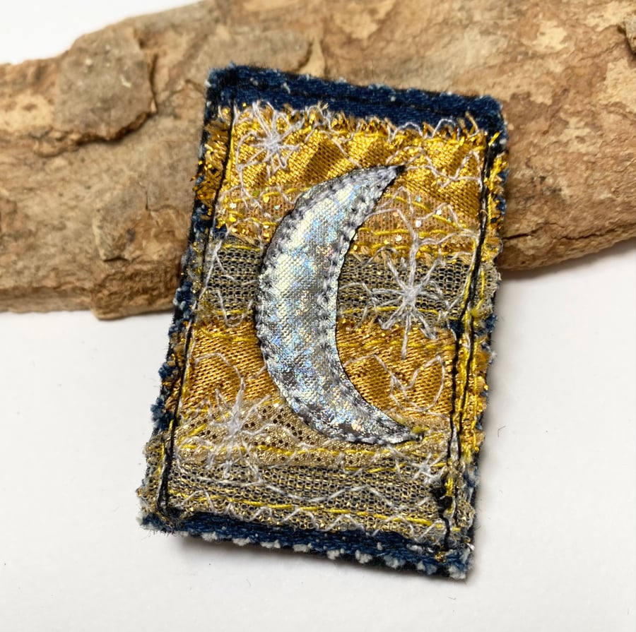 Up-cycled crescent moon on denim brooch pin or badge.