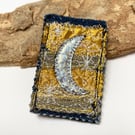 Up-cycled crescent moon on denim brooch pin or badge.