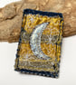 Up-cycled crescent moon on denim brooch pin or badge.