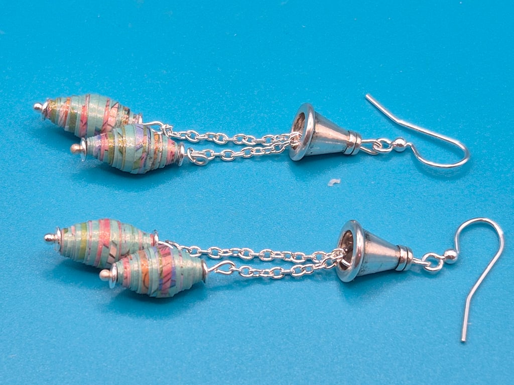 Pastel Blue and pink paper beads dangling from a chain and a tibetan cone