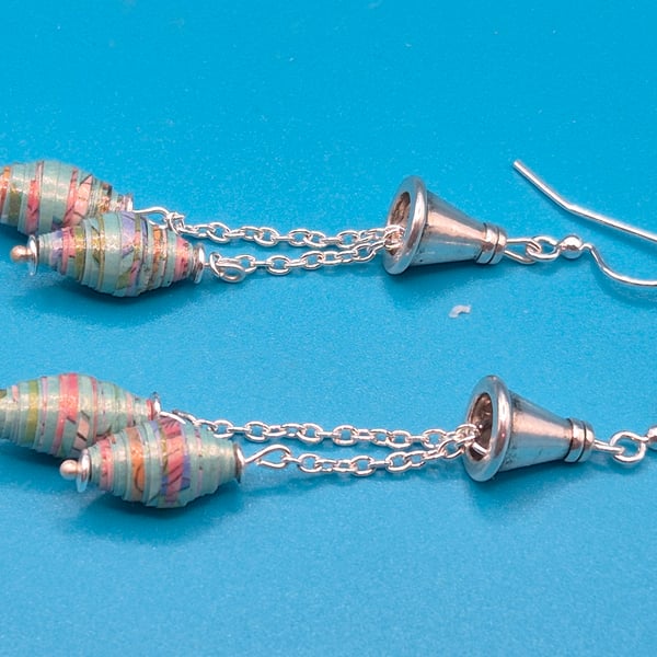 Pastel Blue and pink paper beads dangling from a chain and a tibetan cone