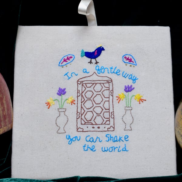 Hand embroidered motivational Gandhi quotation wall art.