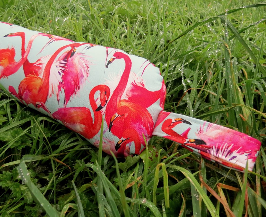 A draught excluder with a flamingos design.  Tropical decor.