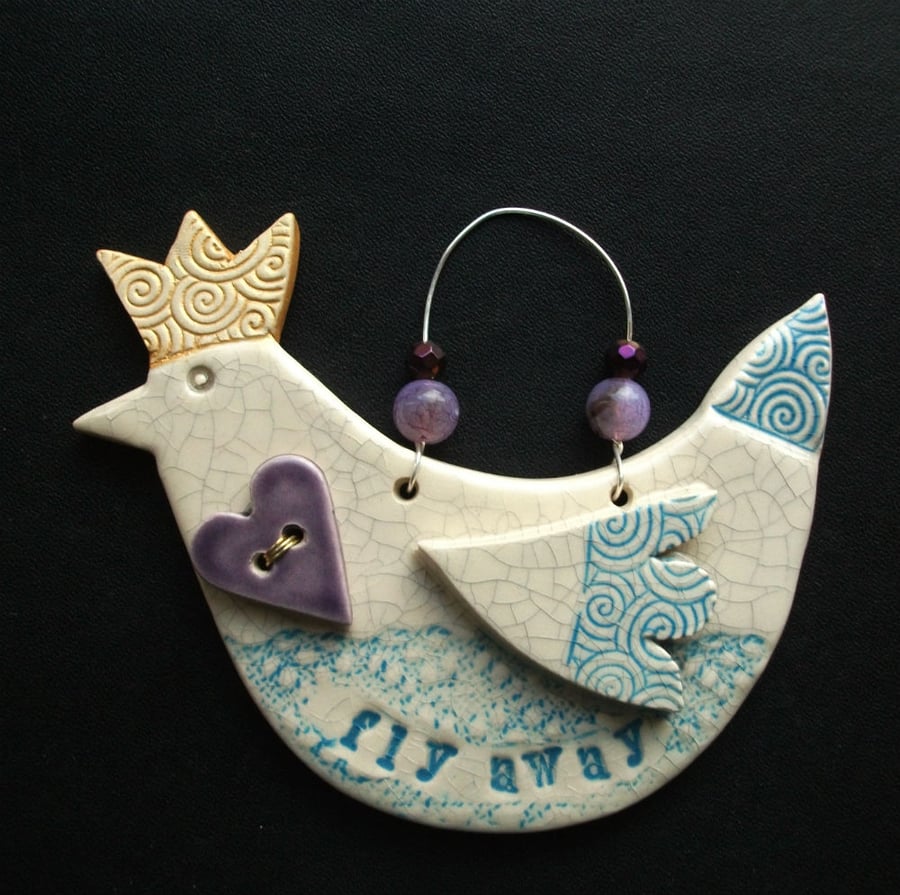Ceramic bird decoration with beads and heart