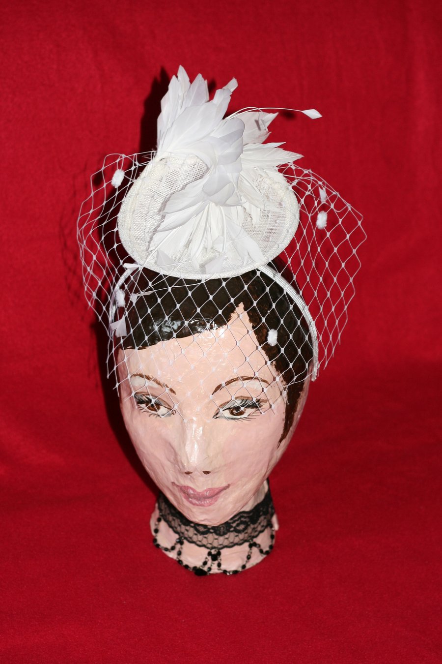 White straw fascinator with feathers and veil