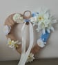 Heart shaped wreath wrapped with burlap and light blue yarn, faux flower decor