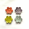 Set of four flower shaped ceramic handmade buttons