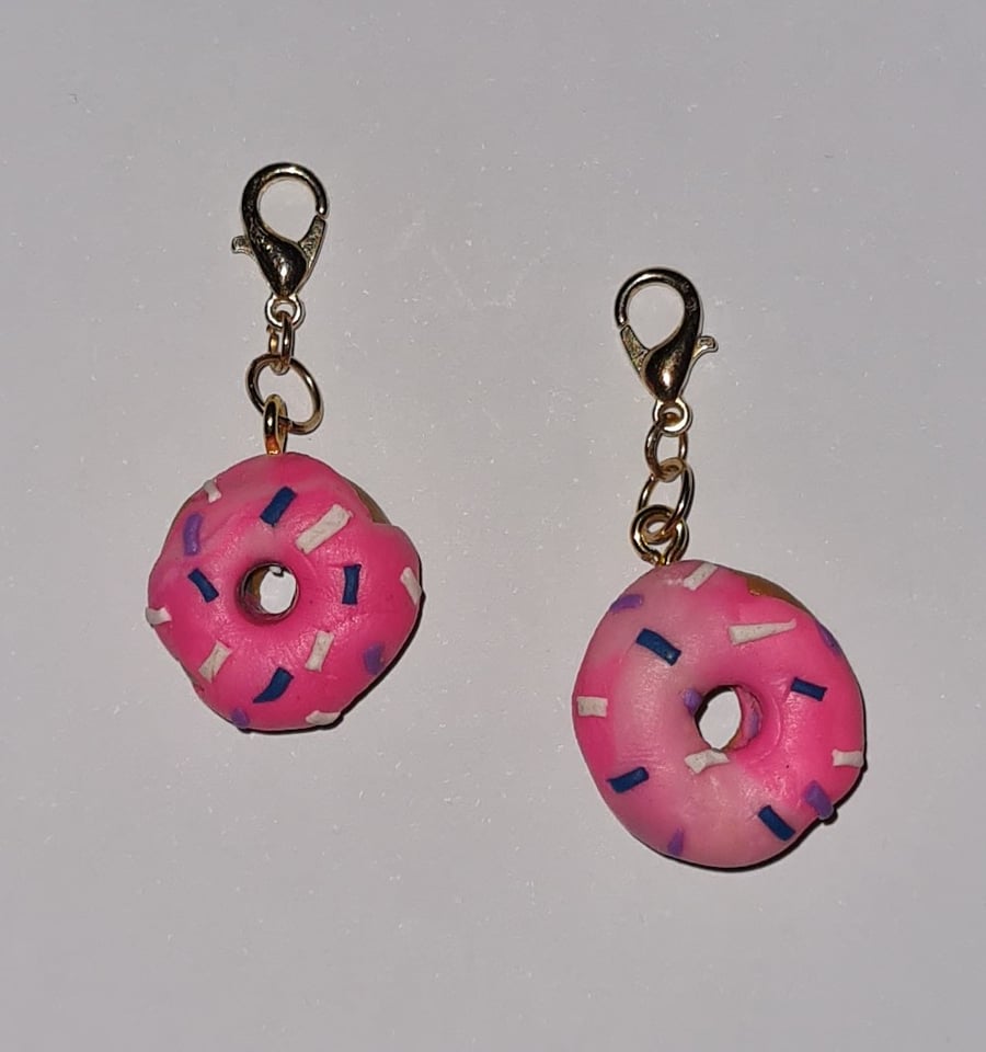 A pair of Pink doughnut bag charms