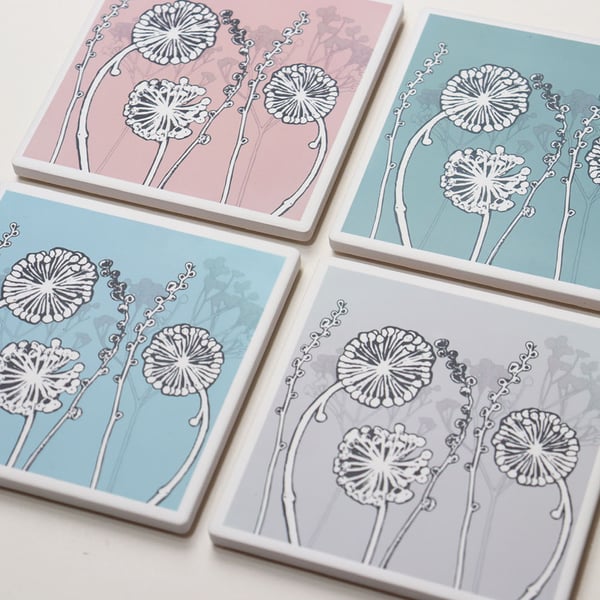 Set of four coloured ceramic sandstone coasters featuring my seedhead design.