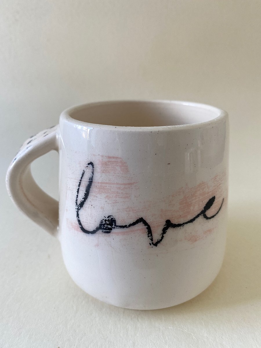Black spot handle ceramic love mug.
