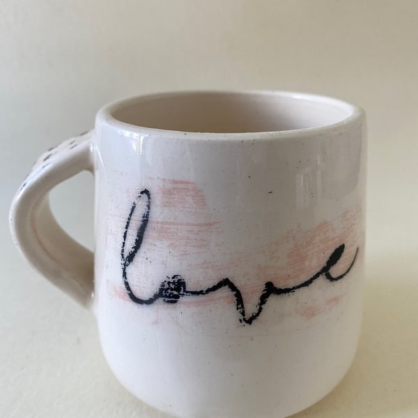 Black spot handle ceramic love mug.