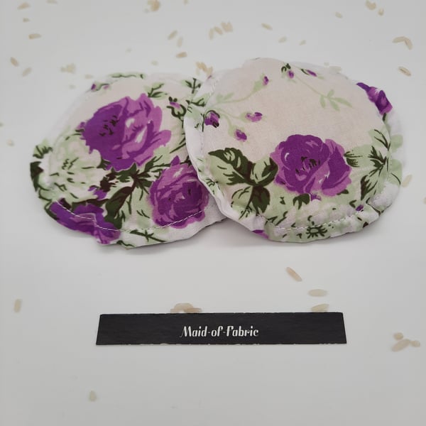 Hand warmers, heat pads rice filled in white floral fabric. 
