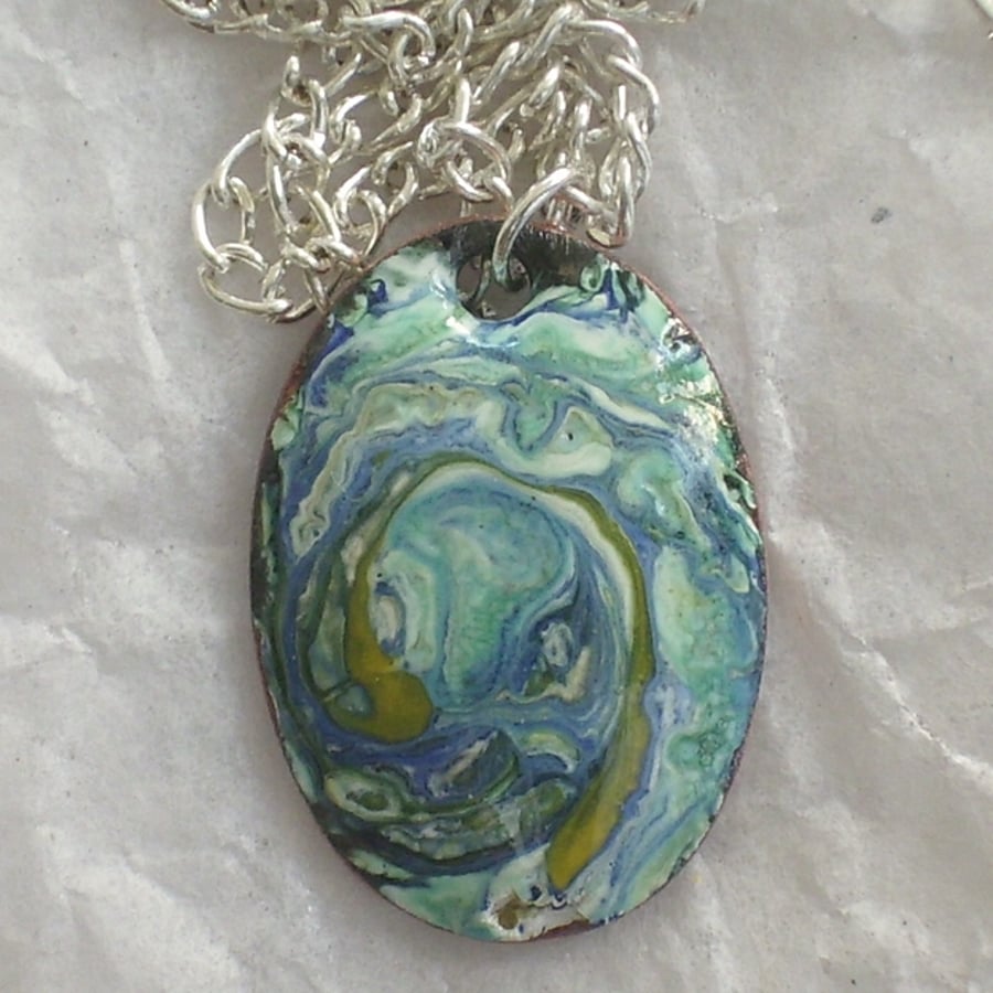 pendant - oval, scrolled blues and yellow on white