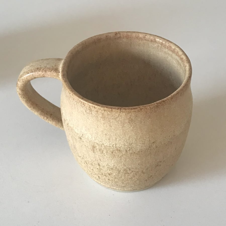  Stoneware pottery mug finished in a natural sandstone glaze.