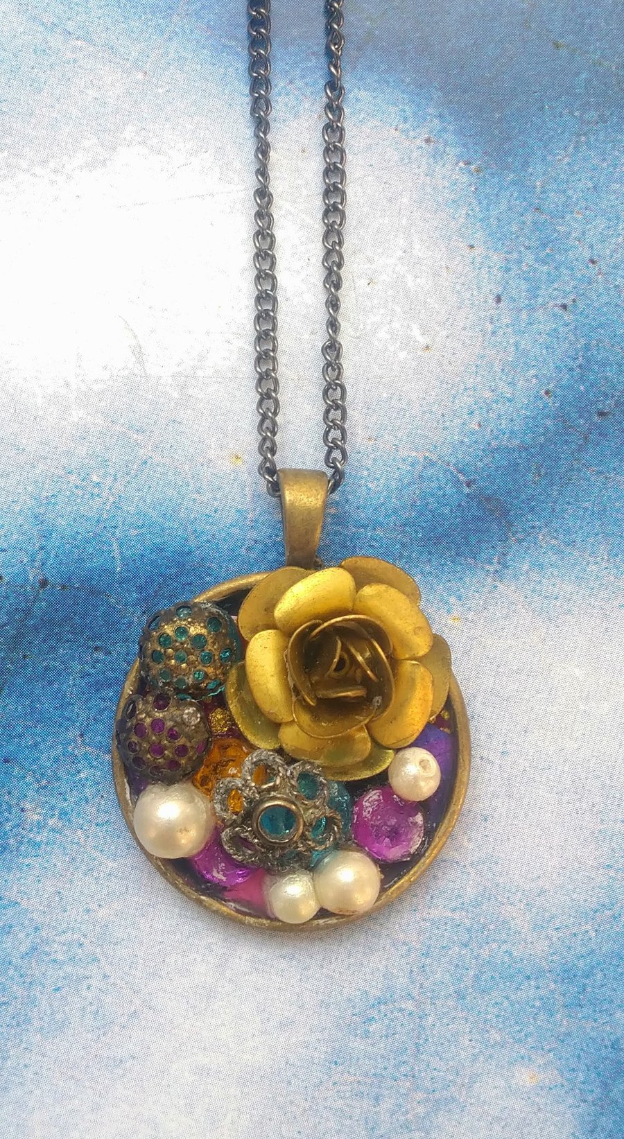 Big Gold Flower in a Bejewelled Pendant