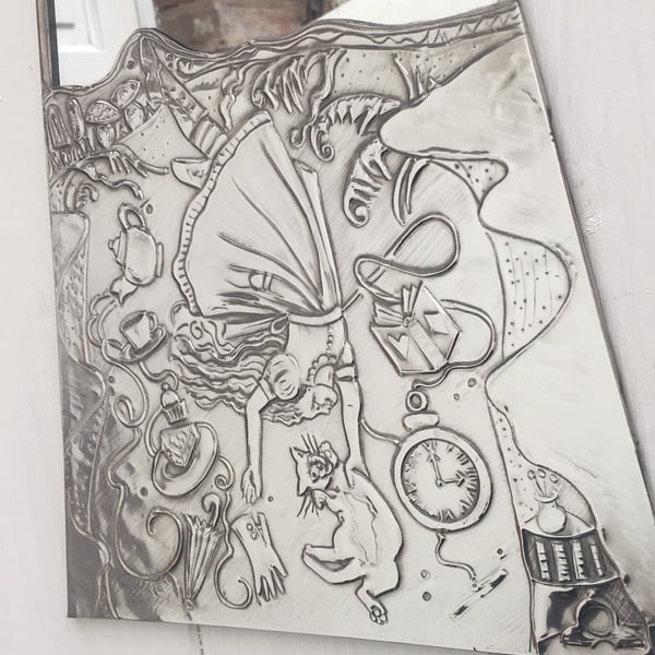 Alice in wonderland mirror. Pewter mirror Alice falling down the rabbit hole.