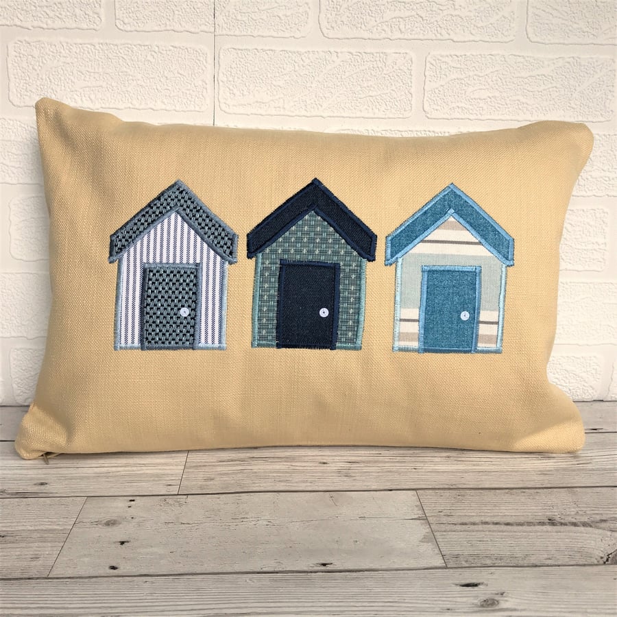 Beach huts cushion in golden yellow with blue and white beach huts
