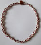 A crocheted necklace in white cotton with bronze bugle beads