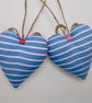 Pair hanging heart decorations on a seaside theme - Image 5