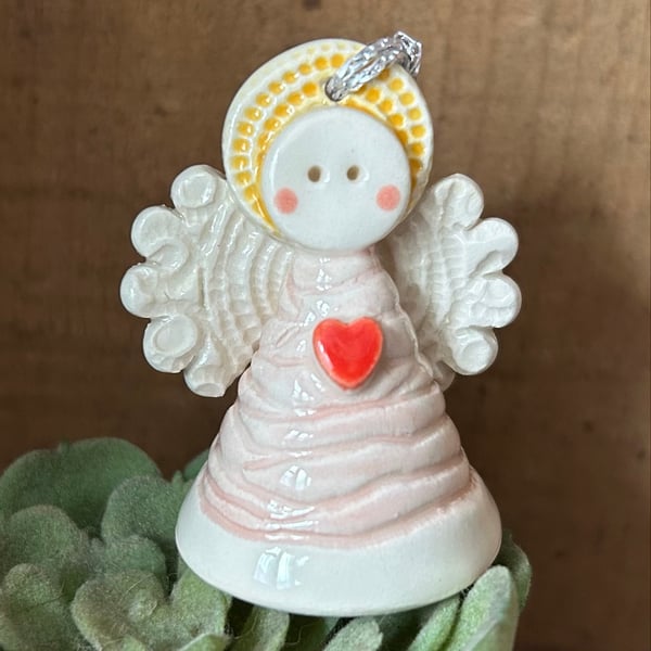 Teeny little ceramic angel with pink dress