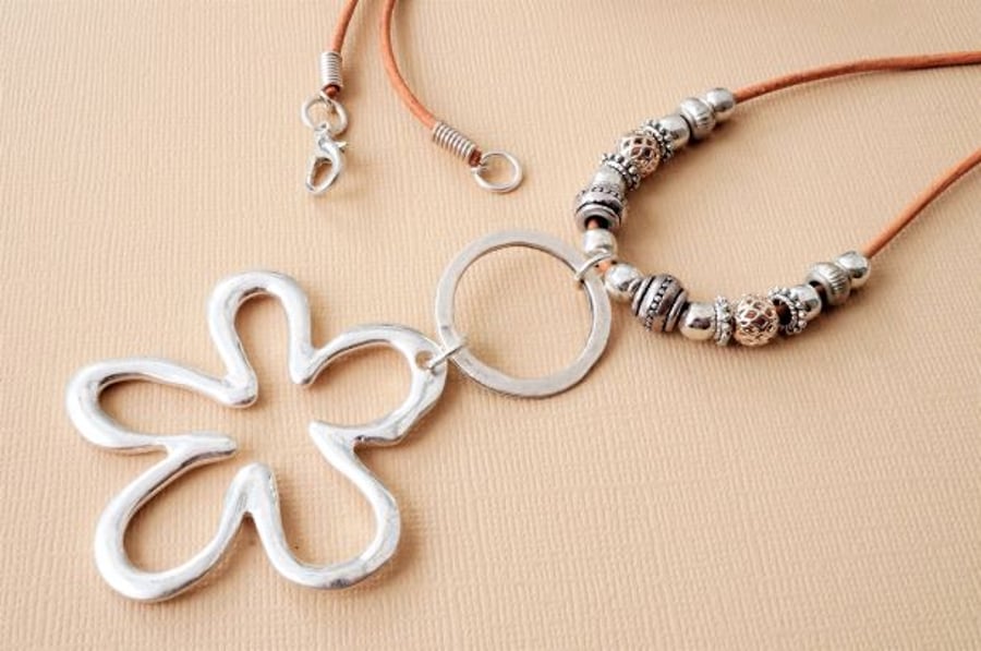 Long boho style leather necklace with silver flower pendant