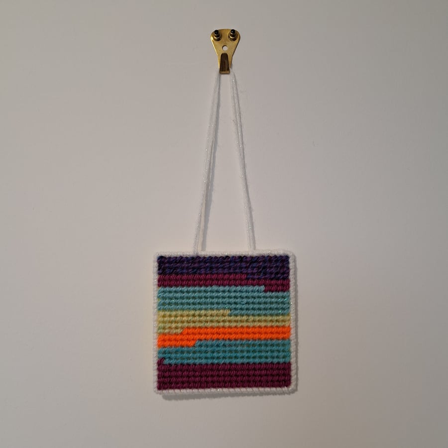 Small wall decoration with abstract landscape pattern, adjustable hang length 