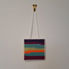 Small wall decoration with abstract landscape pattern, adjustable hang length 