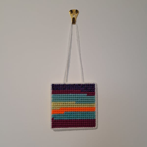 Small wall decoration with abstract landscape pattern, adjustable hang length 