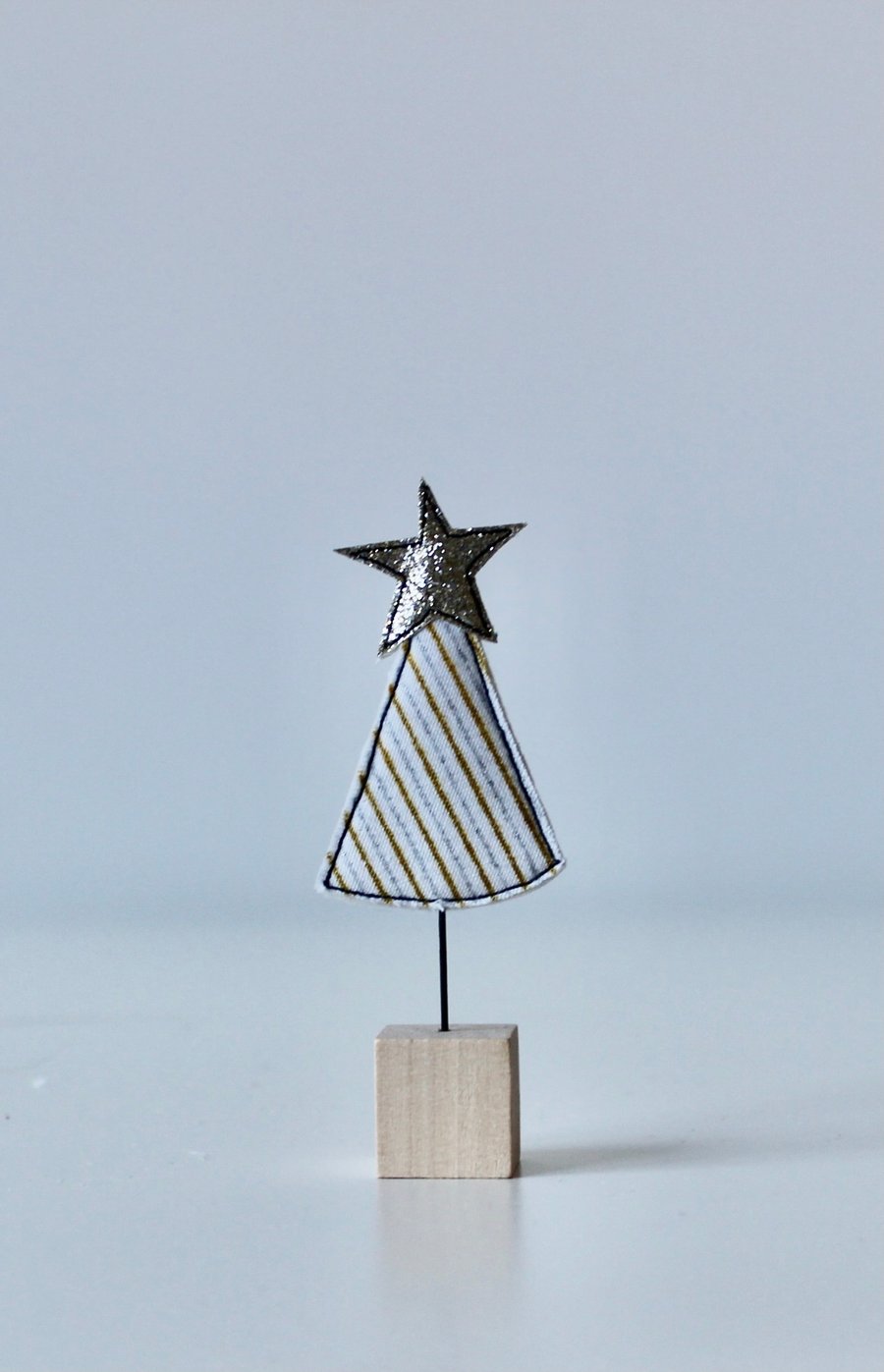 A Christmas Tree with Wire Stem and Wooden Block Stand