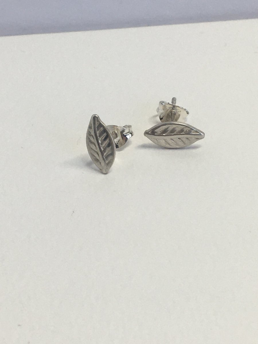 Tiny silver leaf stud earrings