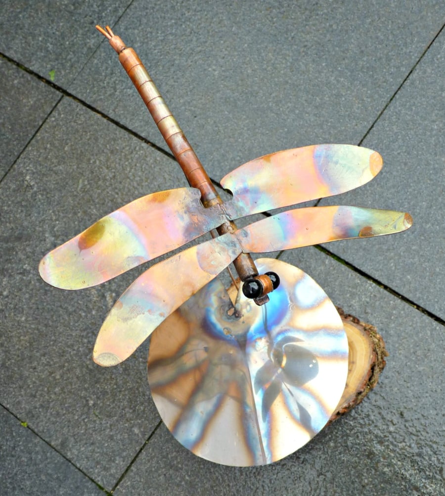 Metal dragonfly over lilypad