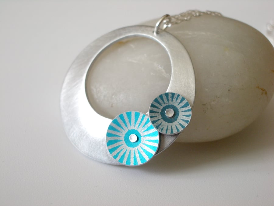 Circle pendant in brushed aluminium with turquoise and teal discs