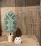 Grey tweed tweed tree with green leaves - Image 1